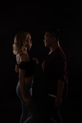 Man and woman dancing to music in the dark