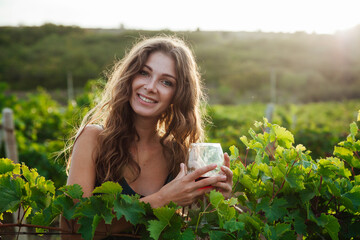 Woman with a glass of wine working i