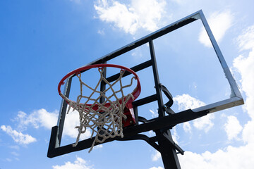 Basketball backboard that is broken, damaged, unusable.