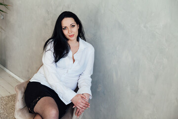 Portrait of a beautiful brunette woman in a white shirt