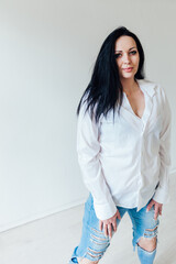 Portrait of a beautiful brunette woman in a white shirt