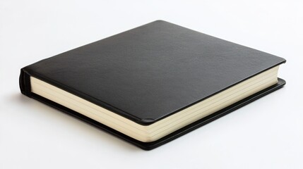 Closed black leather bound book with cream colored pages on a white background