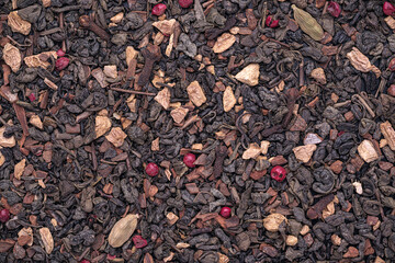 Top view of dried Green tea, Ginger, Cinnamon, Pink peppercorn, Cardamom, clove - Chai Tea