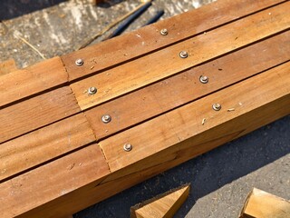Wooden Beams joined and reinforced with multiple metal bolts to structural connections