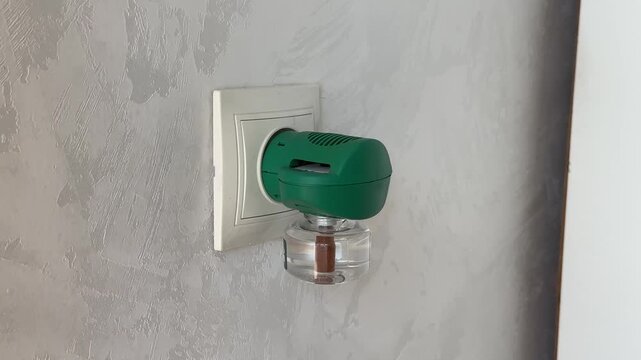 Electric liquid fumigator plugged in. Repellent against mosquitoes, flies, horseflies. Electrofimugator with liquid and plates