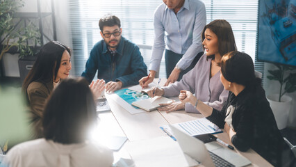Asian professional woman presentation with business team working together meeting at indoor modern office