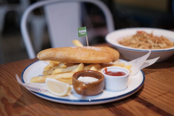 Delicious battered fish and crispy chips served with tartar sauce