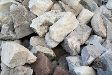 Natural stones and rocks stacked together as construction material for foundation building