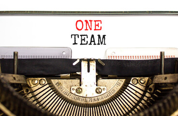 One team symbol. Concept word One team typed on beautiful old retro typewriter. Beautiful white paper background. Business one team concept. Copy space.