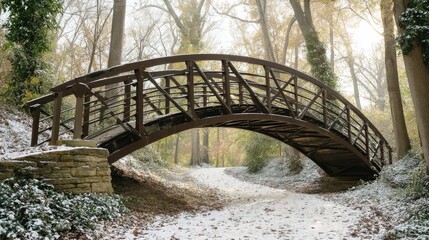 Fototapeta premium A covered bridge over a path in a winter woodland.