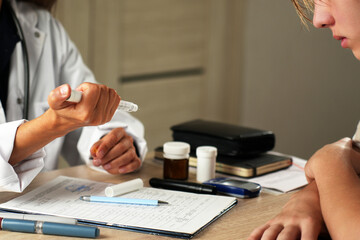 Doctor consulting patient with insulin pen and diabetes medication