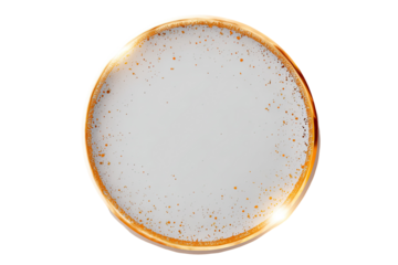 Circular, golden-rimmed, frothy beverage