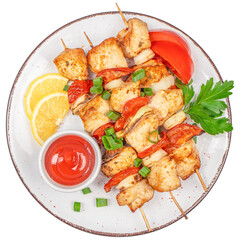 Grilled chicken skewers with vegetables, lemon slices, and sauce on white plate.