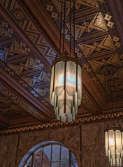 Obraz premium Red and Gold Geometric Pattern Ceiling with White Glass Panel Ceiling Lights.