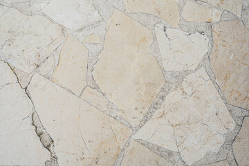 Textura de piso de piedra beige con juntas de cemento irregulares