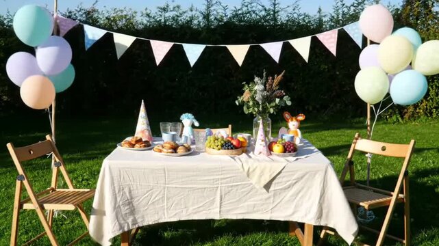 Outdoor party with colorful balloons, bunting, food, and chairs set up on lush green grass for festive events and celebrations. Perfect for invitations, advertisements, and event promotions. - Powered by Adobe