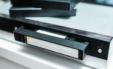 Close up of a hand holding a videotape.