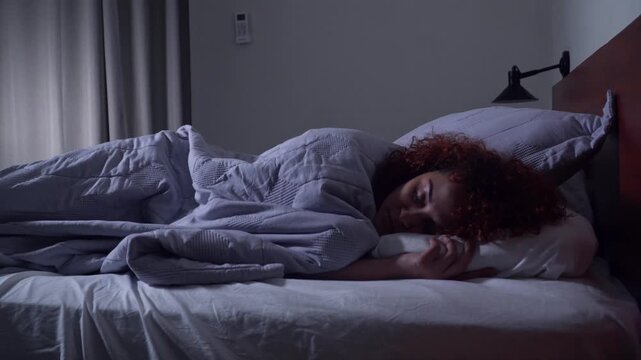 Woman sleeping peacefully in bed at night
