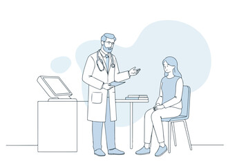 Doctor consults with patient in clinic, with medical computer on desk