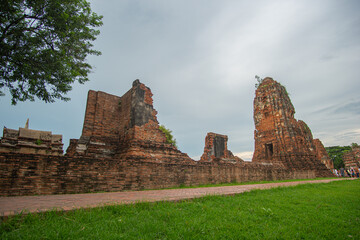 Ruins of an old brick wall at the Religious Historical Park.Wat Phra Ram in the Ayutthaya period was the capital.scenery sunrise white cloud in blue sky It's like being in a historical era
