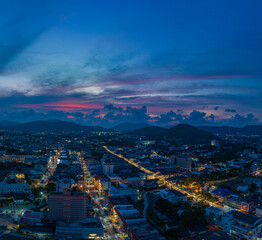 aerial view The lights twinkled along Talang walking street at night.Bright colors along the beach city area at night.beautiful sky in twilight.