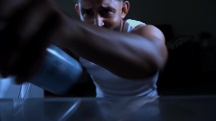 Man looking for food in refrigerator at night