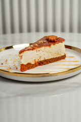 Cheesecake lotus, slice cake. Served on a white plate. Close up, top view