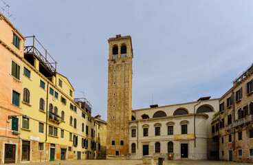 Tall historic bell tower standing in Venetian square