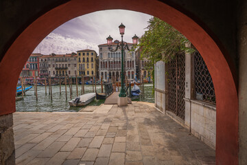 Grand Canal in Venice framed by red archway