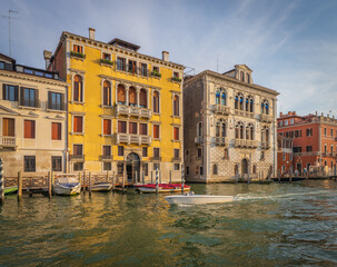 Venetian palaces with gondolas at sunset