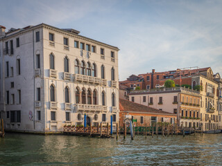 Venetian palaces with gondolas at sunset