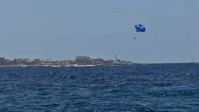 Experience the exhilarating thrill of parasailing high above the stunning coastal scenery beautifully beneath