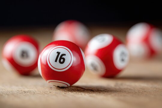 Red lottery balls showing winning numbers on wooden table