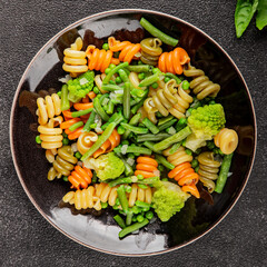 Trottole pasta vegetables green peas, green beans, kohlrabi cabbage, broccoli second course tasty snack fresh delicious gourmet food background on the table rustic food top view copy space