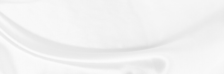 White gray satin texture that is white silver fabric silk panorama background with beautiful soft blur pattern natural.