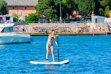 Woman Learning Stand Up Paddle Boarding on Adriatic Sea &ndash; Practice and Falls