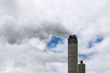 Amsterdam, The Netherlands - August 23rd, 2025 - Steam from the chimneys of waste incinerator AEB in Westpoort harbor