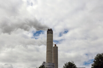 Amsterdam, The Netherlands - August 23rd, 2025 - Steam from the chimneys of waste incinerator AEB in Westpoort harbor