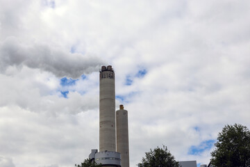Amsterdam, The Netherlands - August 23rd, 2025 - Steam from the chimneys of waste incinerator AEB in Westpoort harbor