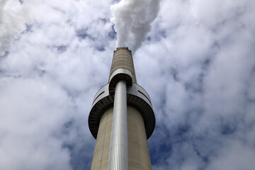 Amsterdam, The Netherlands - August 23rd, 2025 - Steam from the chimneys of waste incinerator AEB in Westpoort harbor
