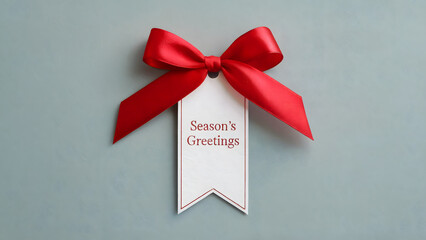 Festive red ribbon and gift tag with Season's Greetings message perfect for holiday promotions