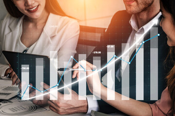 A professional business meeting featuring a diverse team analyzing financial data and charts on a tablet, emphasizing strategy development and collaboration. Impute