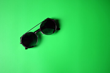 vintage sunglasses on green background