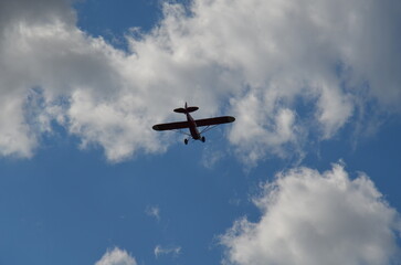 Air show during Polish Aviation Day in Krakow, Poland. Military and civil aircraft performing aerobatic maneuvers in the sky.
