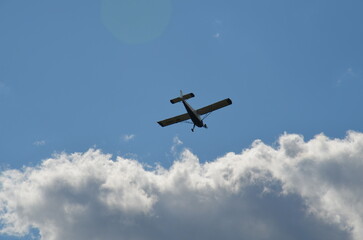 Air show during Polish Aviation Day in Krakow, Poland. Military and civil aircraft performing aerobatic maneuvers in the sky.