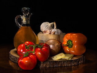 Still life with olive oil and fresh vegetables on wooden pallet, including tomatoes, red and yellow peppers, cheese, onion and garlic, natural light, rustic culinary composition, canvas print.