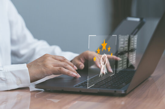 User interacts with laptop showing holographic five-star rating and thumbs-up icon, representing positive customer review and satisfaction.