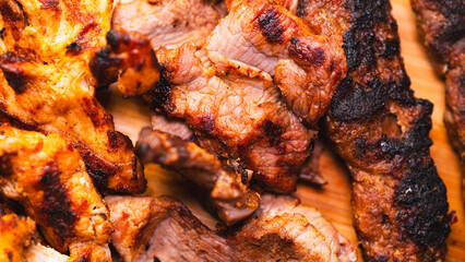 Delicious and healthy mixed grill platter featuring juicy chicken shish, tender lamb shish, and sliced chicken doner kebab. Served on a rustic wooden board. Perfect for food blogs, menus and more.