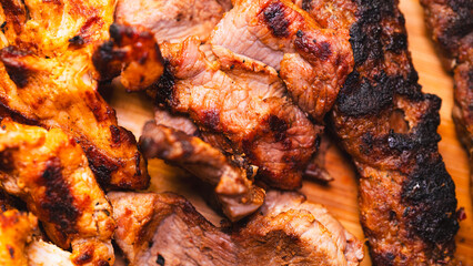 Delicious and healthy mixed grill platter featuring juicy chicken shish, tender lamb shish, and sliced chicken doner kebab. Served on a rustic wooden board. Perfect for food blogs, menus and more.