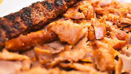 Delicious and healthy mixed grill platter featuring juicy chicken shish, tender lamb shish, and sliced chicken doner kebab. Served on a rustic wooden board. Perfect for food blogs, menus and more.